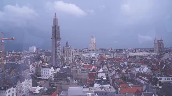 Aerial view of tall commercial buildings of Antwerp, a beautiful urban cityscape. Dark rain clouds f alt