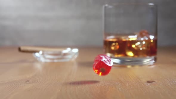 Dice and Glass of Whiskey on a Wooden Table