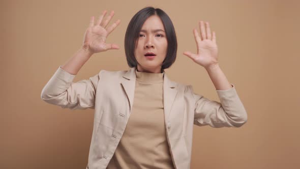 Asian business woman happy relax and dancing isolated over beige background. 4K video