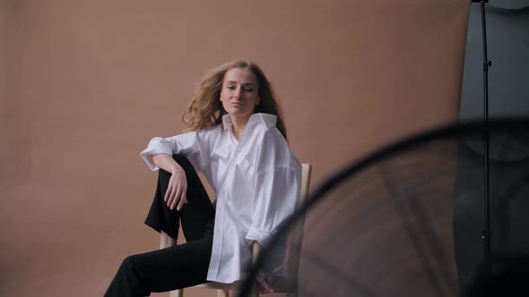 Professional Fashion Shoot of a Young Sexy Caucasian Woman in White Loose Shirt