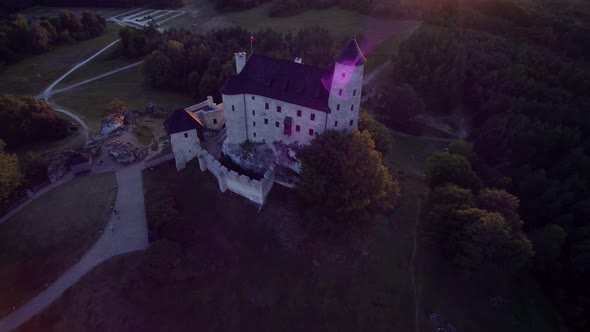 Castle in the forest, sunset, view from a drone 4K