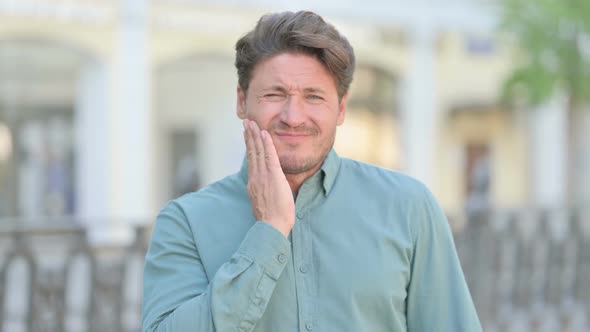 Outdoor Middle Aged Man having Toothache, Cavity alt