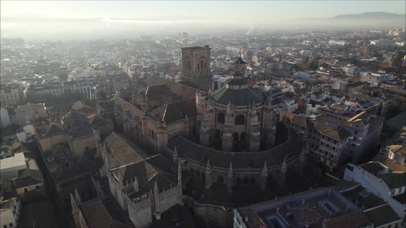 Aerial orbit around the majestic Granada Cathedral with surrounding city