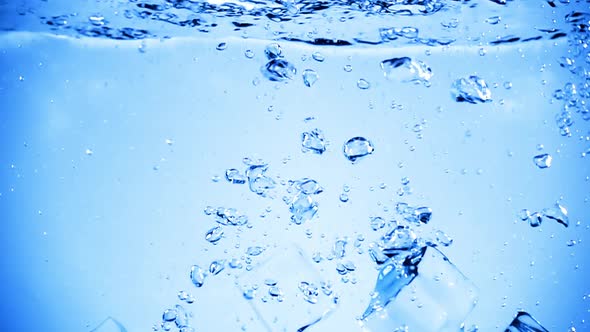 Ice Cubes Dropped Into Water with Air Bubbles alt