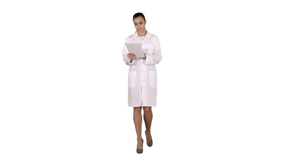 Doctor Using Tablet While Walking on White Background. alt