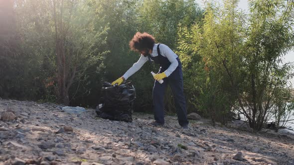 Adult Male Volunteer Pickup and Collecting Garbage on Beach alt