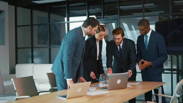 Corporate business team in a meeting. Group of young people in suits alt