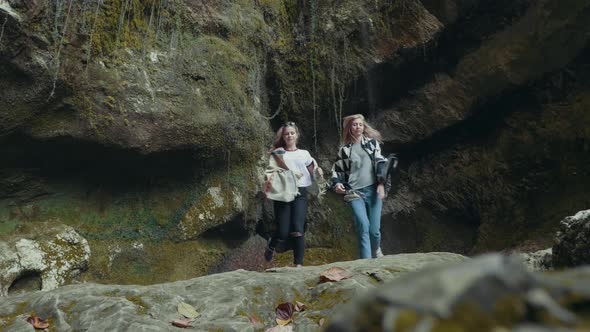 Tourists Walking Along the Canyon in the Mountains in Summer