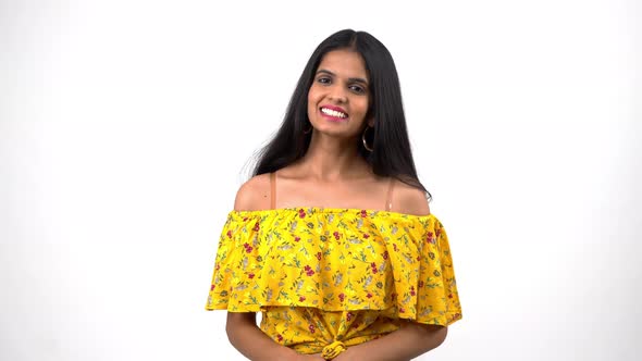 A beautiful and attractive Indian girl smiling and laughing towards the camera alt