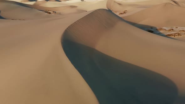 Cinematic View of High Sand Dunes in Sunset Light Deep Shadows From Sand Peaks alt