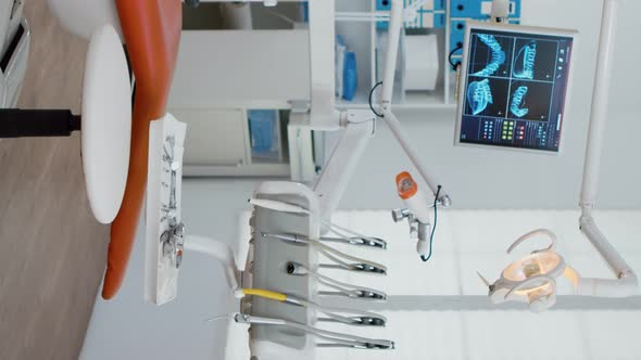 Vertical Video Interior of Modern Equipment Oral Office with Teeth x Ray on Monitors alt