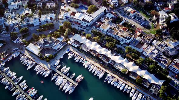 View from drone on full of yachts Bodrum harbour and ancient Kalesi castle in Mugla in Turkey alt