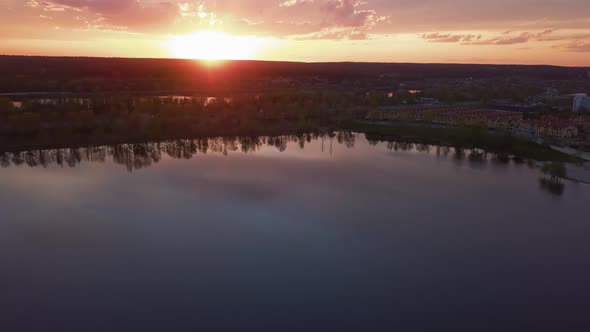 Beautiful Sunset with Clouds Over the River Under Construction Houses in the Dark Ukraine Kiev on