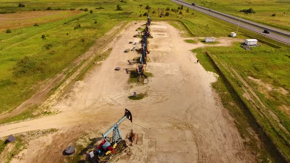 Aerial view of the row of oil derricks in summer alt