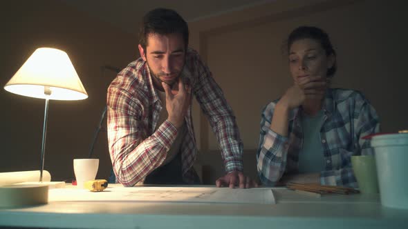 Couple checking the project of their new house