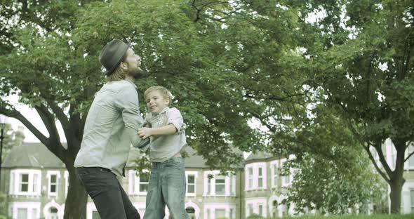 Father lifting up son outside