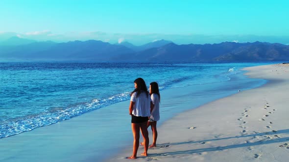 Women look beautiful on relaxing resort beach holiday by shallow lagoon with white sandy background  alt