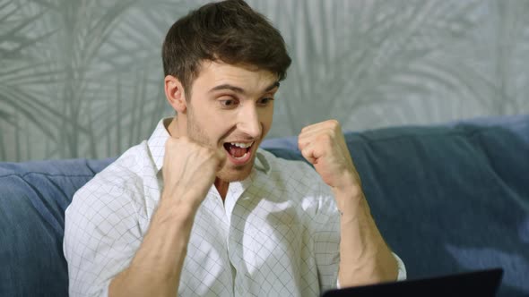 Surprised Man Getting Message Computer. Excited Businessman Celebrating Success alt