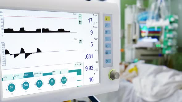 Patient in ICU with Lung Ventilation on Foreground
