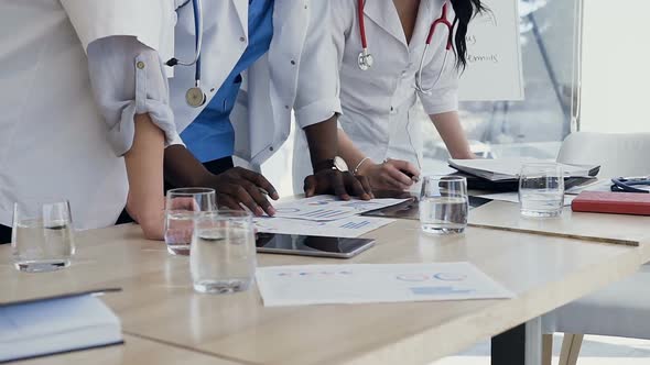 Hands of Three Doctors During Discussing Result  alt