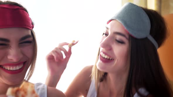 Graceful Girls in Sleeping Masks Eating Pizza. alt