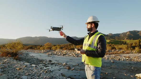 geologist with drone checks the territory alt