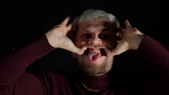 Stylish Young Man Looking at Camera Feeling Happiness Fun and Enjoyment Showing Smile Gesture alt