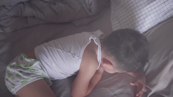 Slow motion High angle shot of a little two years old Asian boy wearing summer sleeping clothes slow alt