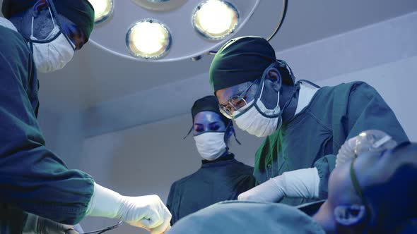 Medical surgical doctor team performing surgery patient alt