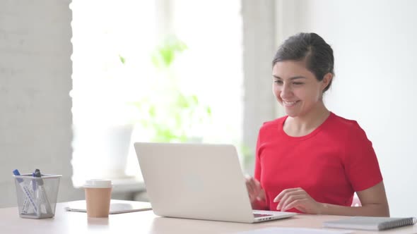 Indian Woman Talking on Video Call on Laptop in Office alt