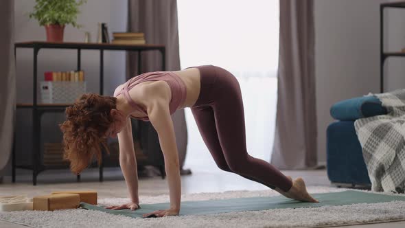 Adho Mukha Shwanasana and Meditation at Morning Woman is Training Alone in Apartment Doing Physical alt