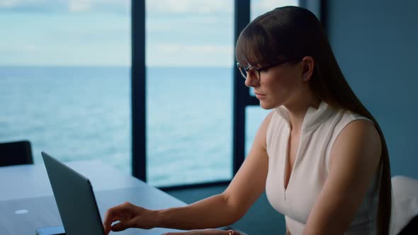 Focused Manager Type Laptop in Glass Office alt