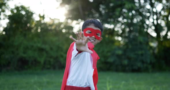 Hero boy in red have power at garden alt