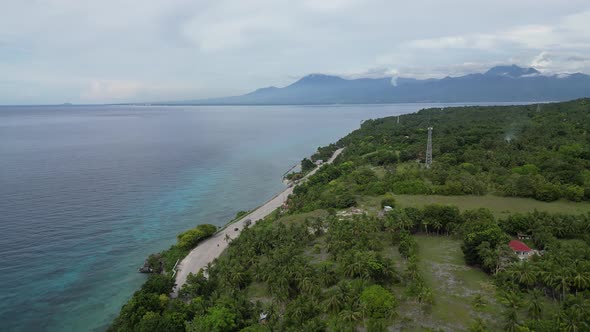 The Drone Flies Over a Tropical Island in the Philippines the Road Runs Along the Seashore