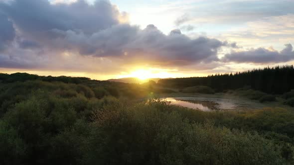 Flying Into the Sunrise Over a Peatbog in County Donegal - Ireland. alt