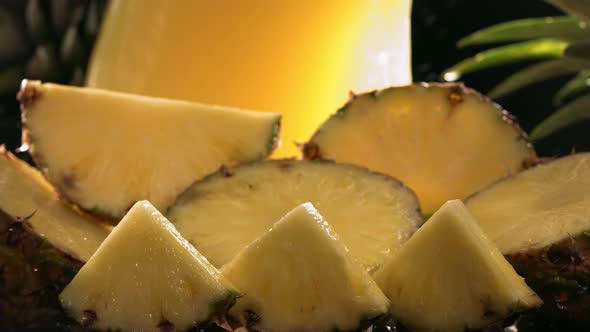 Slow Motion Shot of Pineapple and Juice Splashing Through Pineapple Slices alt