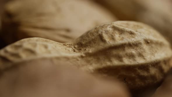 Cinematic, rotating shot of a variety of nuts on a white surface - NUTS MIXED 044 alt