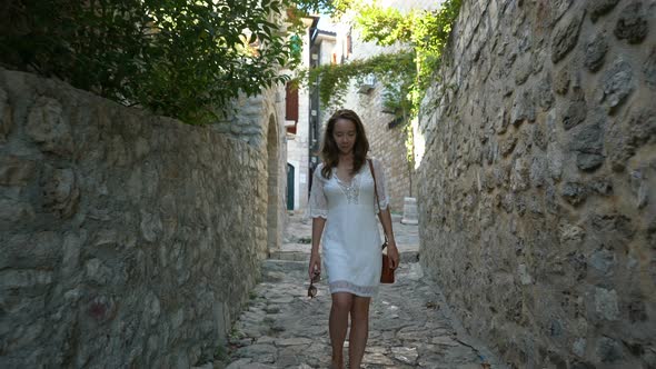 Young Woman Walks the Streets of the Old City of Ulcinj
