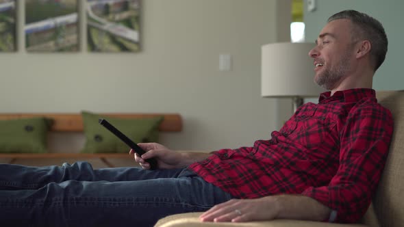 Man Laughing at a Funny Show