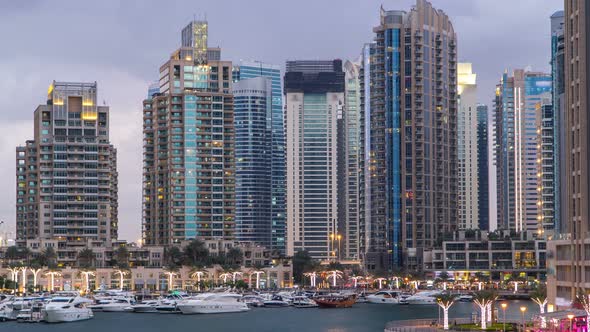View of Dubai Marina Towers and Canal in Dubai Day to Night Timelapse alt
