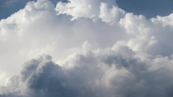 Timelapse of White Puffy Cumulus Clouds Forming on Summer Blue Sky alt