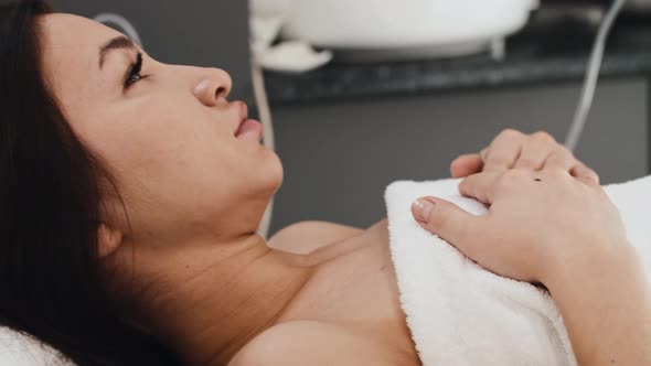 Young Brunette Woman Having LPG Massage Session on Her Stomach alt