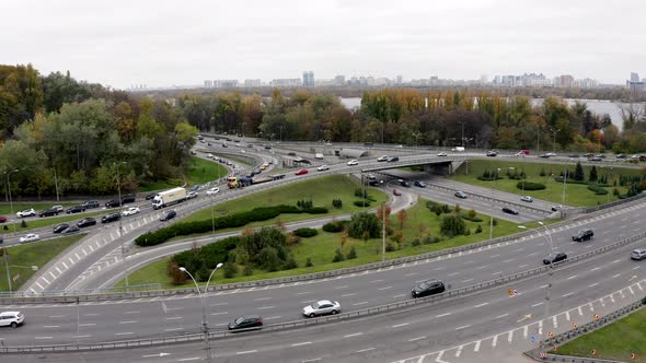 Flying above City. Aerial view of Traffic. Rush Hour on intersection circle. alt