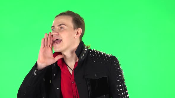 Guy Screams Calling Someone on a Green Screen at Studio. Green Screen alt