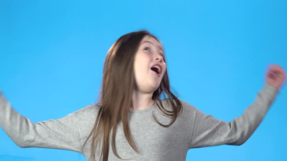 Blonde Teenager Jumping for Joy, Smiling, Looking at the Camera alt