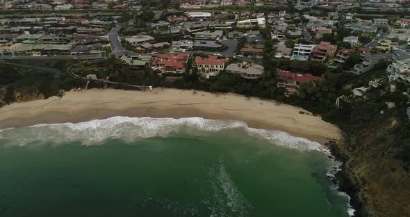 Aerial of secluded beach in Laguna Beach, CA. camera dollies to left. alt