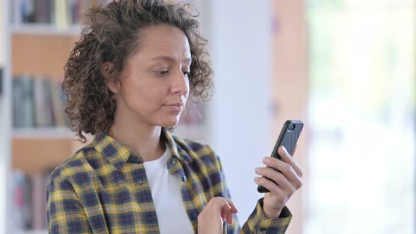 Portrait of Mixed Race Woman Using Smartphone alt