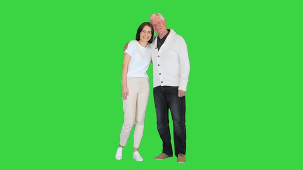 Adult Granddaughter and Elderly 80s Grandfather Smiling on Camera on a Green Screen Chroma Key alt