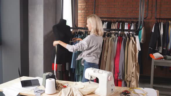 Attractive Fashion Designer Measuring Mannequin alt