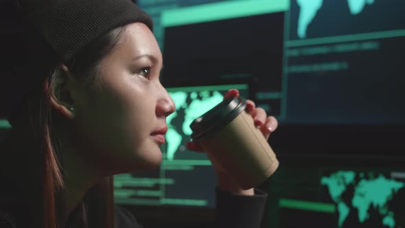 Close Up Young Asian Woman Hacker Using Computer Hacking And Drinking Coffee alt